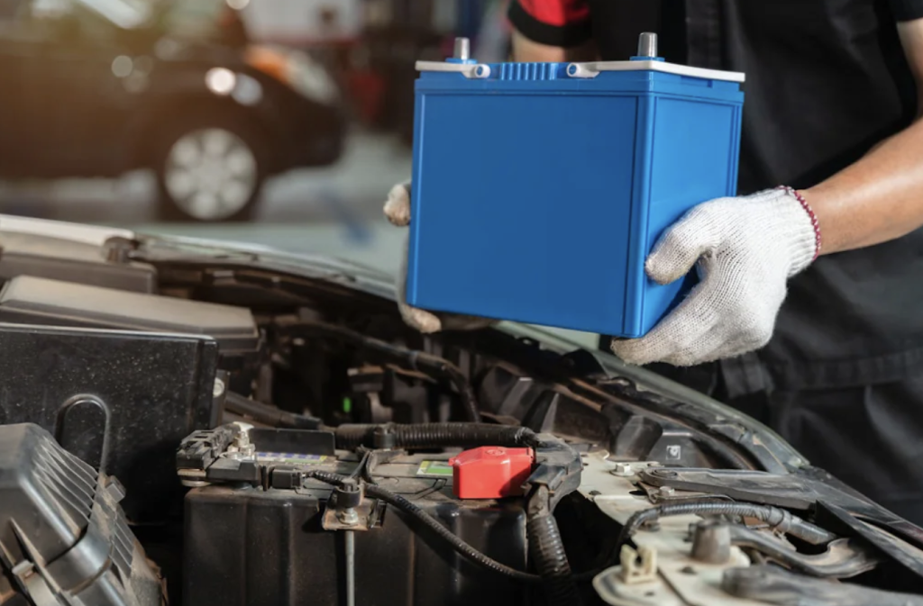 Mechanic replacing a car battery